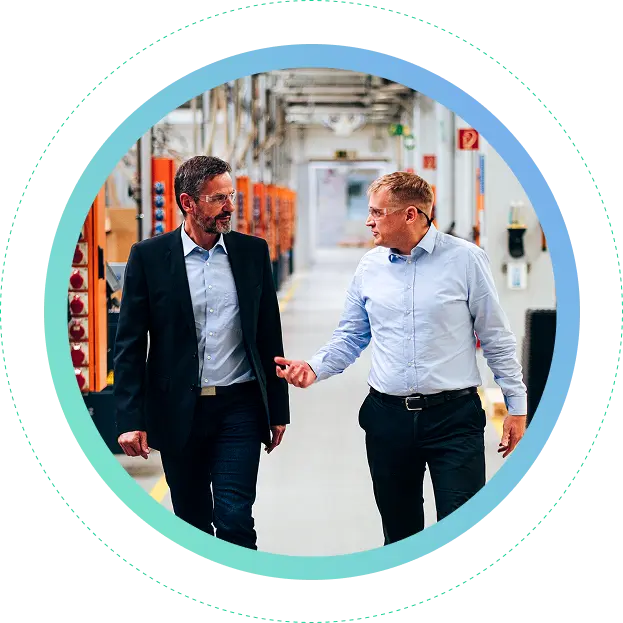 2 intelycx workers walking in factory