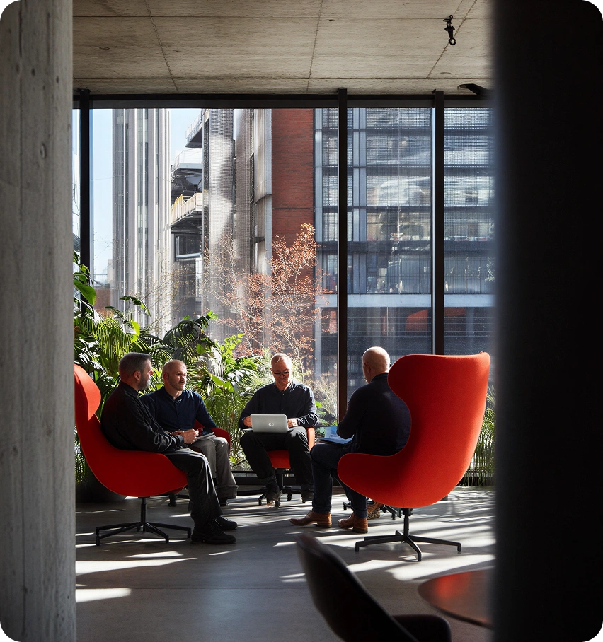 The Intelycx team collaborating in a shared workspace